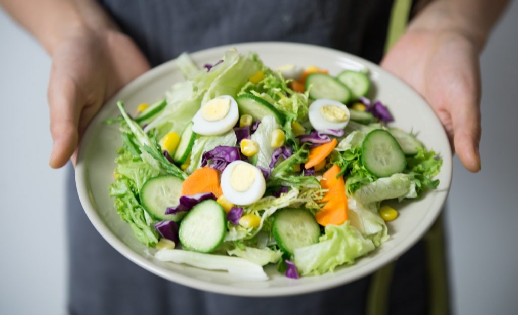 Person holding a healthy food in a blo