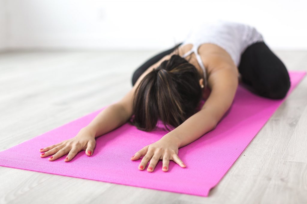 Young women meditate on a mat