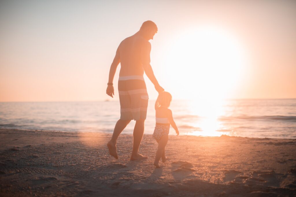 man holding a child's hand